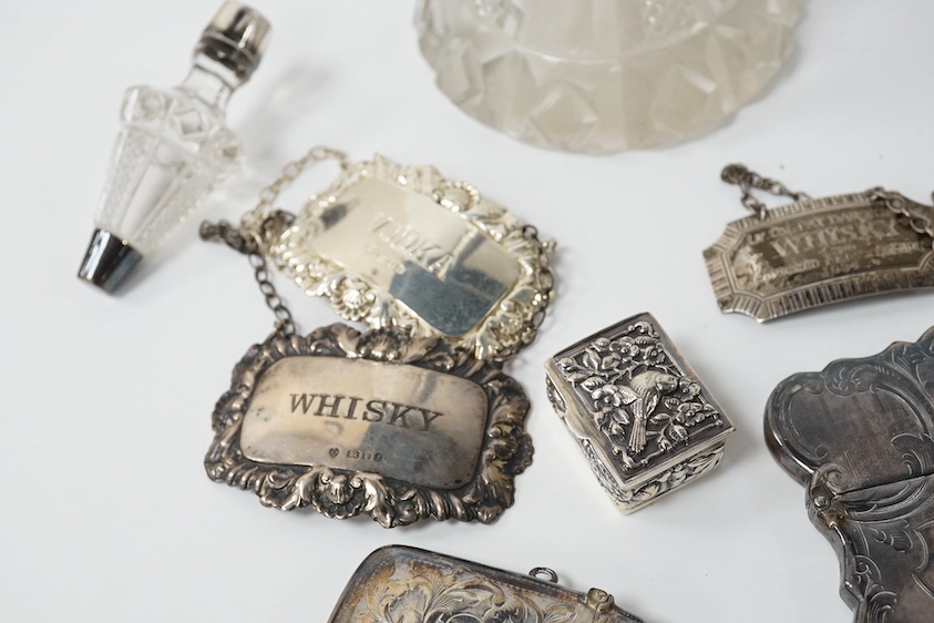 A small group of collectable silver including a Victorian engraved card case, Hilliard & Thomason, Birmingham, 1856, 10cm, three modern wine labels, a vesta case, a 925 pill box and an Edwardian mounted glass scent bottl